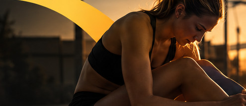Runner training on a track in warm golden evening light