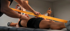 Athlete working with a trainer during a gym exercise